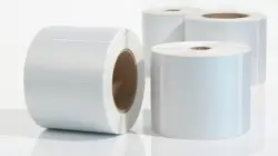Wei&szlig;e Etikettenrollen als Symbol f&uuml;r die Anf&auml;nge der industriellen Kennzeichnung bei der Gr&uuml;ndung von Labelident im Jahr 2004.